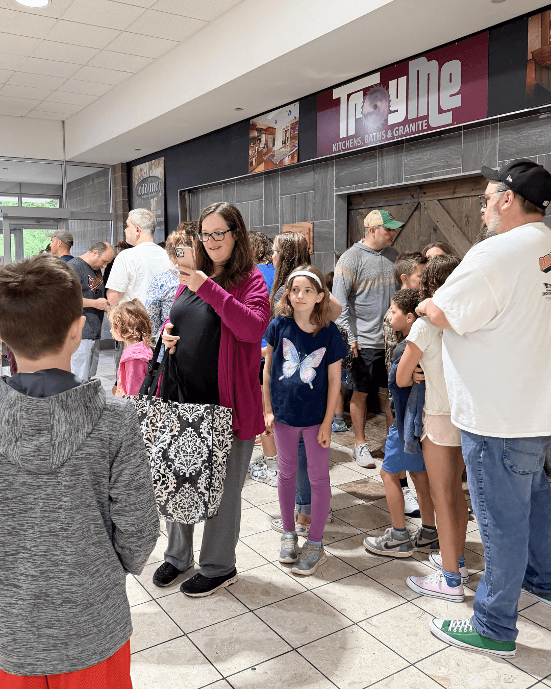 Families gathering in the theater lobby