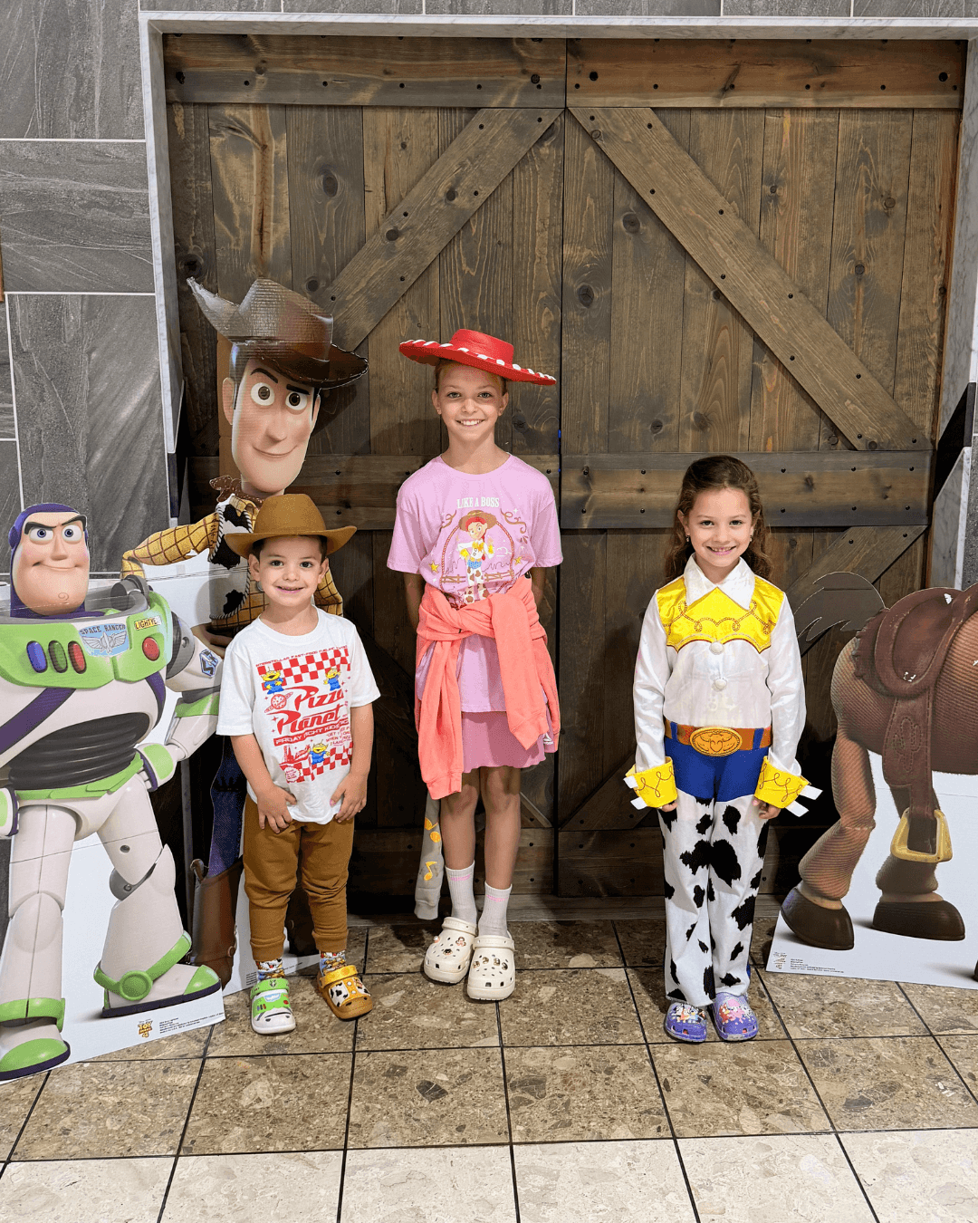 Costume contest participants posing with Toy Story characters